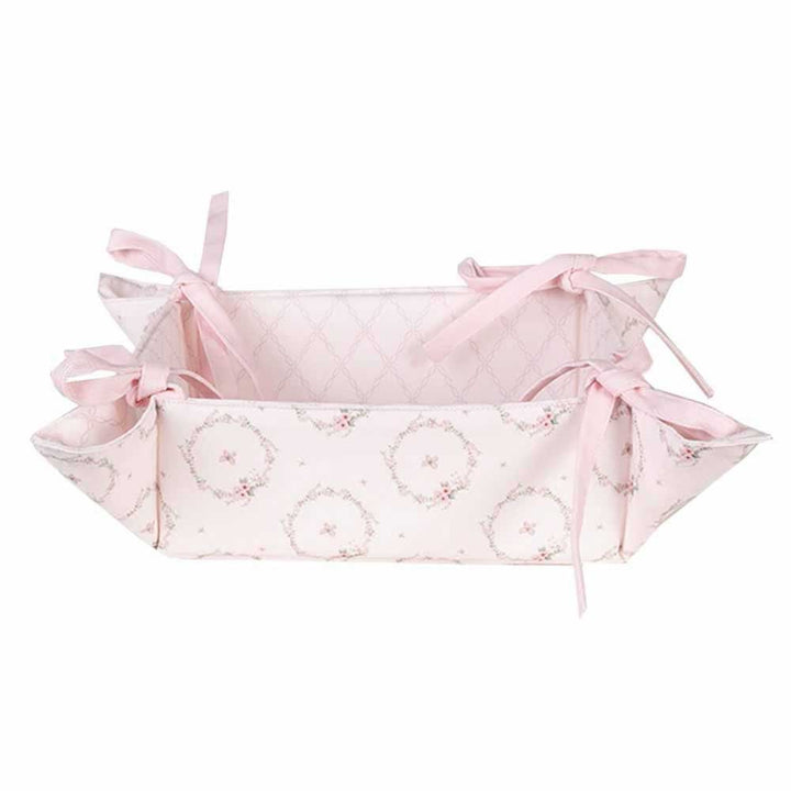 Ein Clayre & Eef - Brotkorb Hase Rosa mit Schleifen darauf.