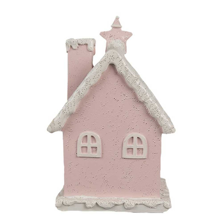 Ein Clayre & Eef - Lebkuchenhaus mit LED 15 cm Rosa, bestehend aus einer rosa Hausskulptur mit einem weißen, schneeähnlichen Dach, einem Schornstein mit einem Stern darauf und zwei abgerundeten Fenstern.