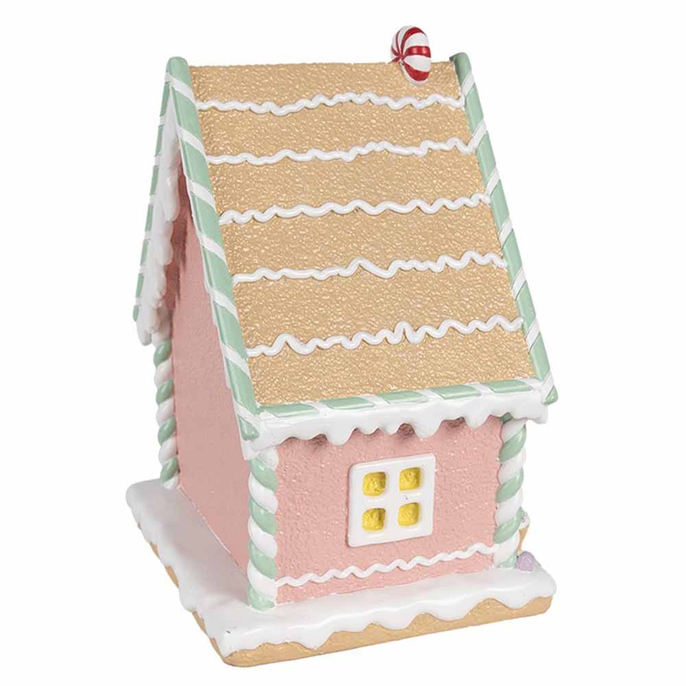 Das Lebkuchenhaus Pastell 25 cm von Clayre & Eef ist ein kleines, dekoratives Haus im Lebkuchenstil mit rosa Wänden, grün-weißen Verzierungen und einem Zuckerguss-Akzent auf dem Dach.