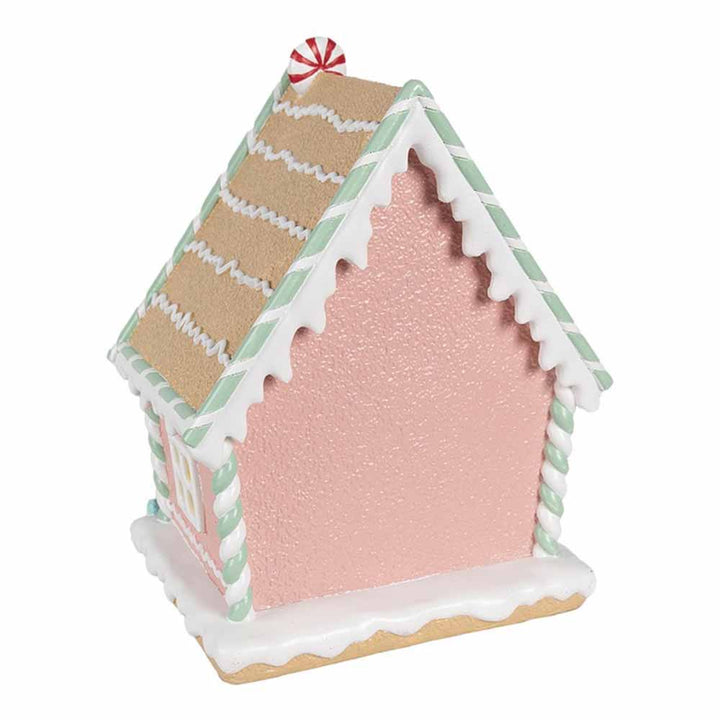 Das Clayre & Eef - Lebkuchenhaus Pastell 25 cm ist ein bezauberndes rosa Lebkuchenhaus mit braunem Dach, detaillierter weißer Glasur und grün-weiß gestreiften Rändern. Für eine zusätzliche festliche Note ist es mit einem Pfefferminzbonbon garniert.