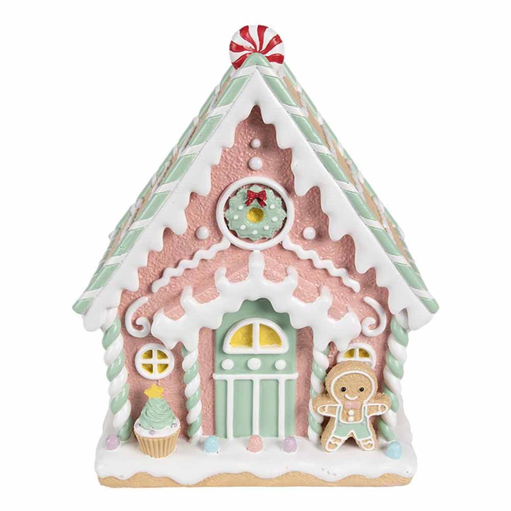 Das Clayre & Eef - Lebkuchenhaus Pastell 25 cm ist ein in Pastellfarben gehaltenes Lebkuchenhaus aus Keramik mit Süßigkeitendetails, einer grünen Tür und einem Lebkuchenmann als Dekoration.