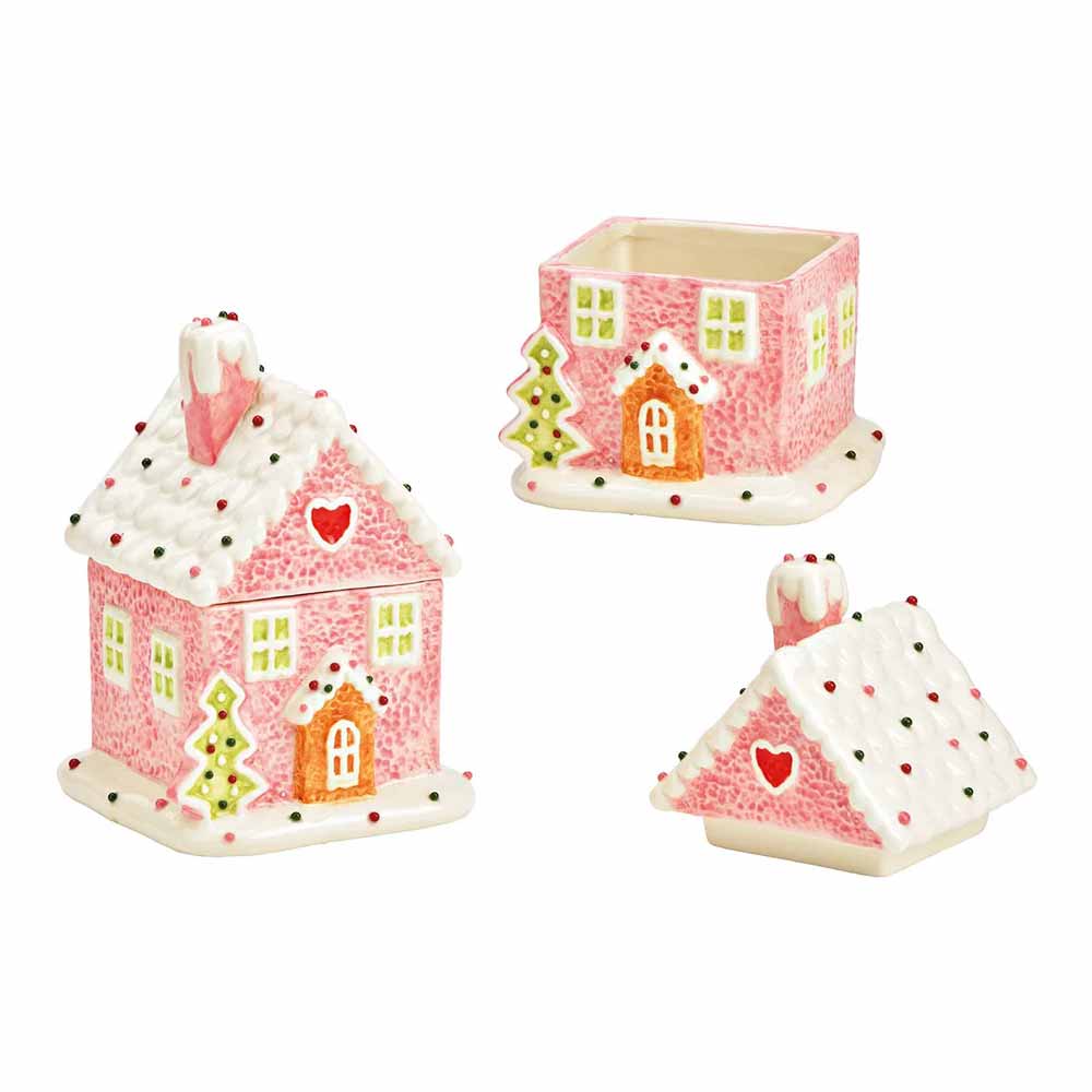 Drei Lebkuchenhausbehälter aus Keramik von G. Wurm mit rosa Wänden, weißen Dächern und bunten Details mit Herz- und Baummotiven.