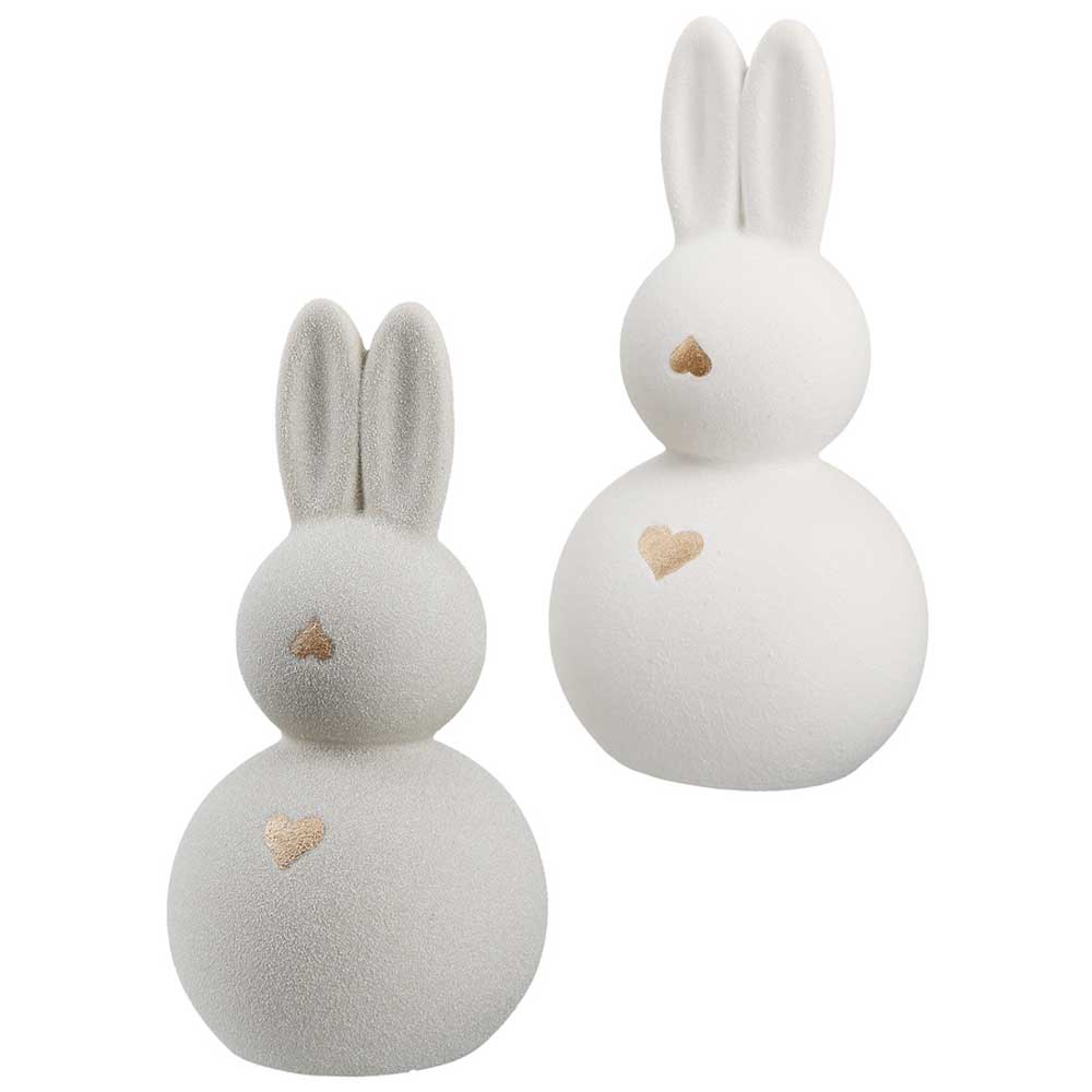 Der Gilde - Osterhase mit Goldherz Keramik umfasst zwei weiße Hasenfiguren aus Keramik mit rundem Körper, langen Ohren und einem kleinen Herz auf der Brust.