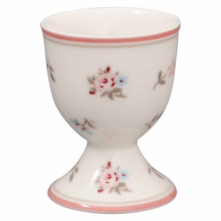 Ein weißer GreenGate - Junia Eierbecher, geschmückt mit rosa und blauen Blumenmustern und einem rosa Rand oben und unten.