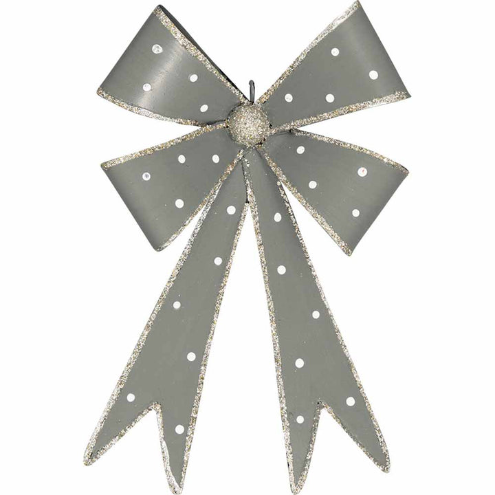 Eine GreenGate - Schleife Metall mit glitzernden Kanten und einem Knoten in der Mitte, geschmückt mit langen, herabhängenden Bandenden.