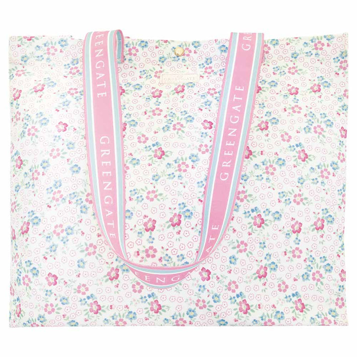 GreenGate - Shopper Allyna: Geräumige Tragetasche mit pastellfarbenem Blumendesign, rosafarbenen Henkeln und dem wiederholt aufgedruckten "GREENGATE" in Weiß.