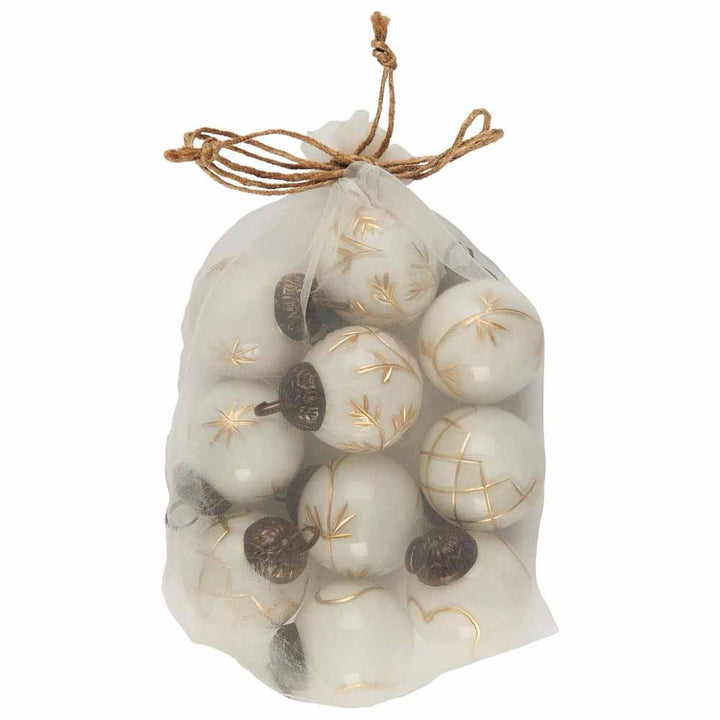 In einem Netzbeutel sind Mini-Weihnachtskugeln von Ib Laursen mit weißen und goldenen Gravuren enthalten.