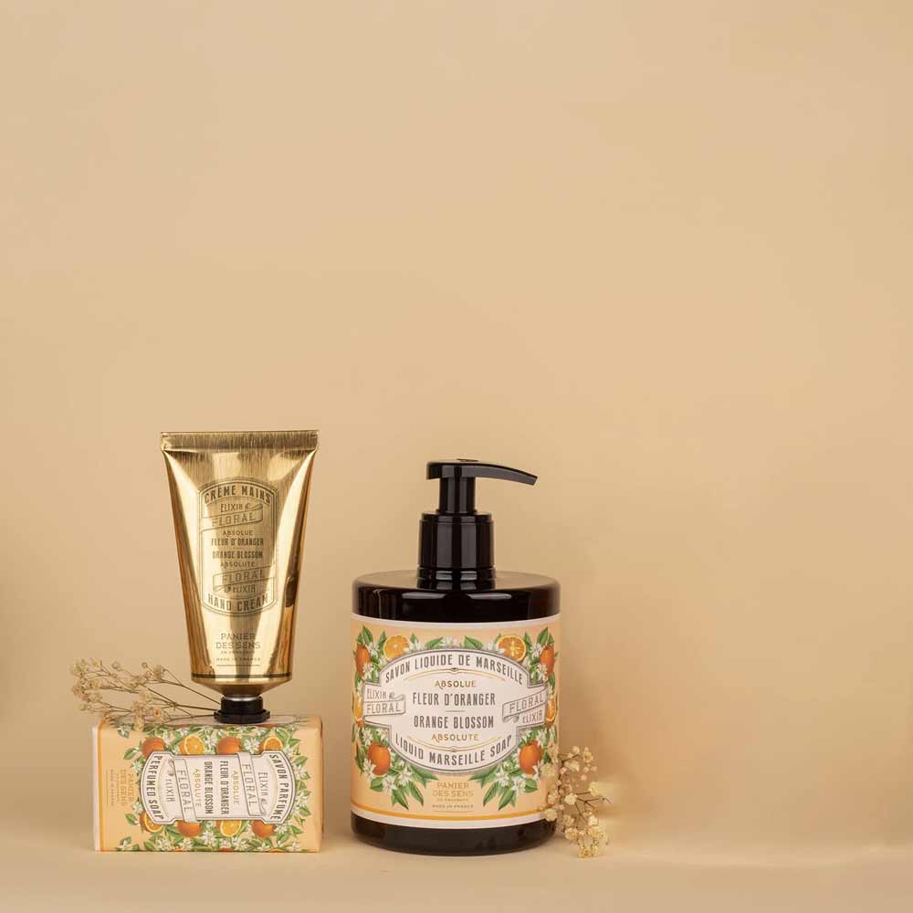Kosmetikprodukte mit Panier des Sens - Handcreme Orangenblüte-Motiv auf beigem Hintergrund.