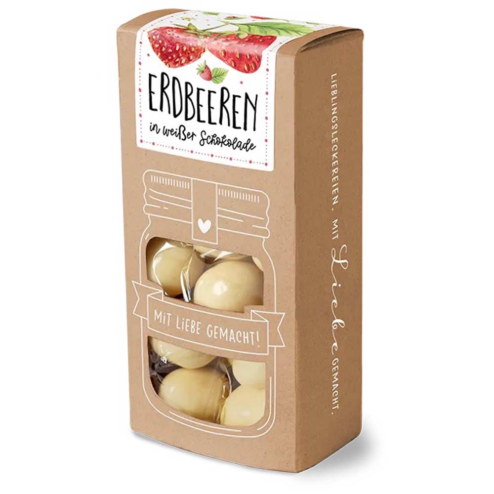 Auf einer braunen Pappschachtel ist „Tee-Maass – Erdbeeren in weißer Schokolade 100 g“ abgebildet, mit einem Sichtfenster, das mit weißer Schokolade überzogene Erdbeeren zeigt, und einer Erdbeerillustration auf dem Etikett.