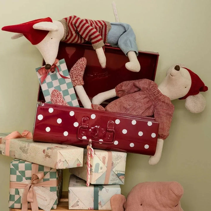 Die Maileg - Weihnachtsmaus Maxi ist eine aufrecht sitzende Plüschmaus, die mit einer roten Mütze, einem gestreiften Pullover und einer blauen Hose ausgestattet ist.