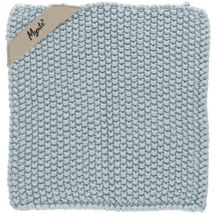 Hellblaues gestricktes Geschirrtuch mit einem beigen Etikett mit der Aufschrift „Ib Laursen – Topflappen Mynte“ in der oberen rechten Ecke.